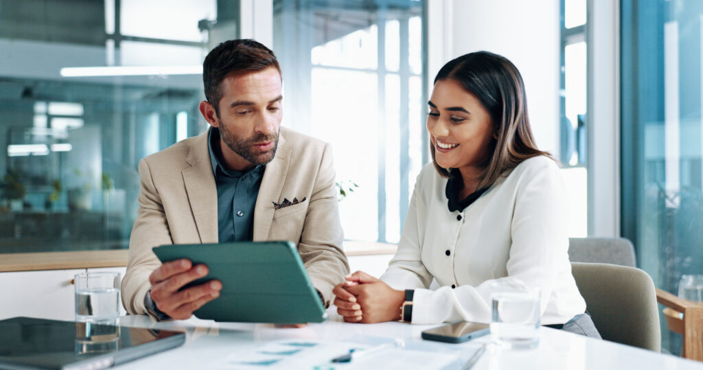 Woman man and meeting on tablet at office of planning financial document and company growth People discussion and online information for paperwork profit graph and investment report and feedback - Trade Info Nvidia, investičnej generácie, akcie