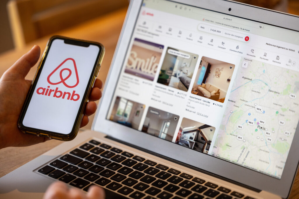 Paris France - November 30 2023 Female hand holding smartphone with Airbnb application Airbnb is an online marketplace and hospitality service enabling people rent short-term lodging - Trade Info krypto, Airbnb