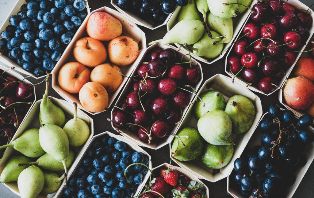Summer fruit and berry assortment in wooden eco-friendly boxes - Trade Info ovocie