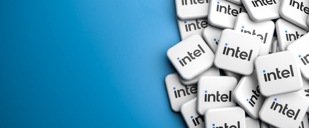 Logos of the tech company Intel on a heap on a table Copy space Web banner format - Trade Info Intel