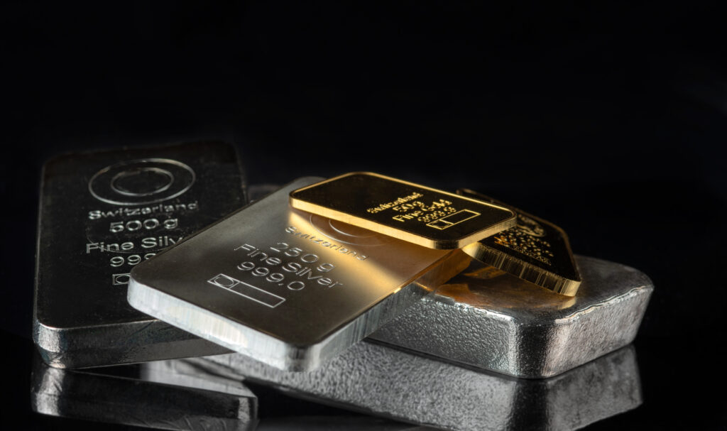 Gold and silver bars of various weights on a dark background Selective focus - Trade Info Zlato a striebro