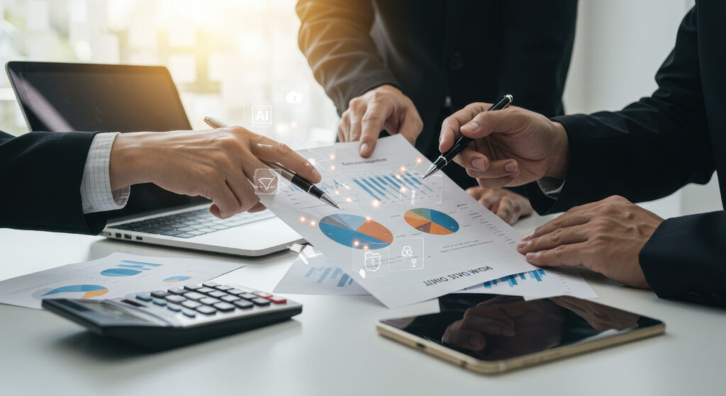 Business Analysis Three professionals in suits strategize using charts and tech devices to optimize investment opportunities in a bright office setting - Trade Info
