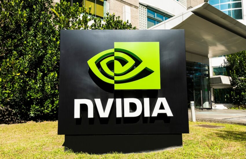 Outdoor Nvidia sign with green eye-shaped logo and white NVIDIA text on a black panel near a modern building entrance.