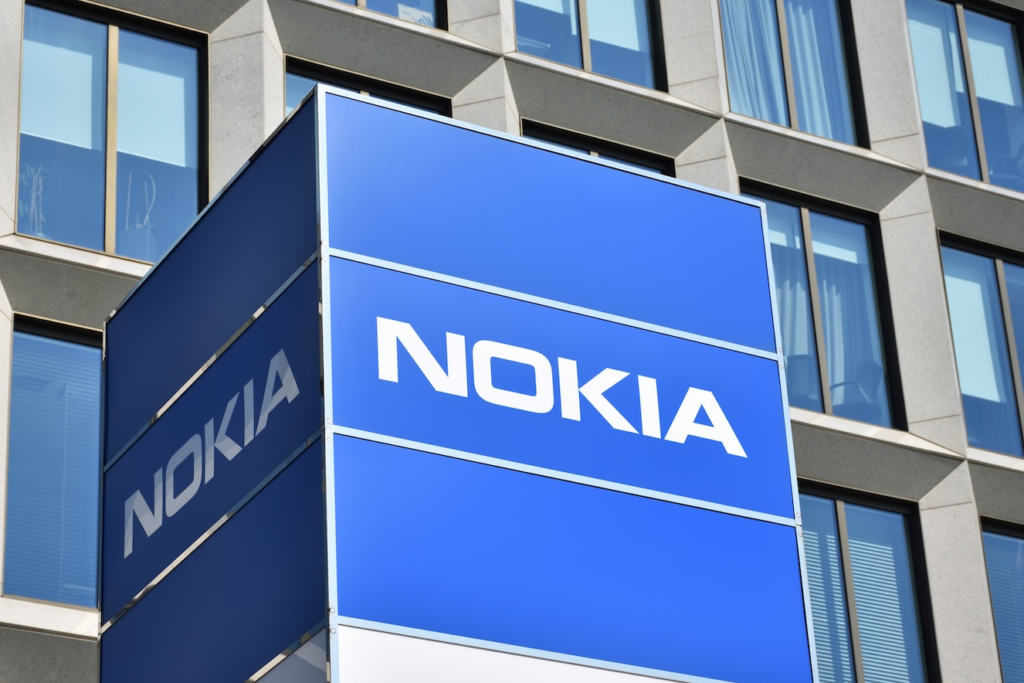 image - Trade Info Blue Nokia storefront sign on a modern glass-and-concrete building exterior.