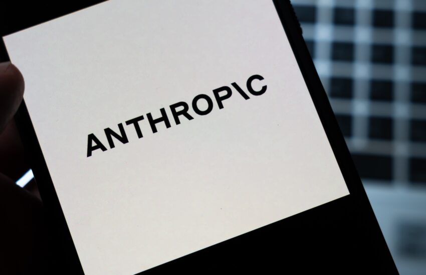 Tilted tablet screen displaying the bold word ANTHROPIC on a white background.